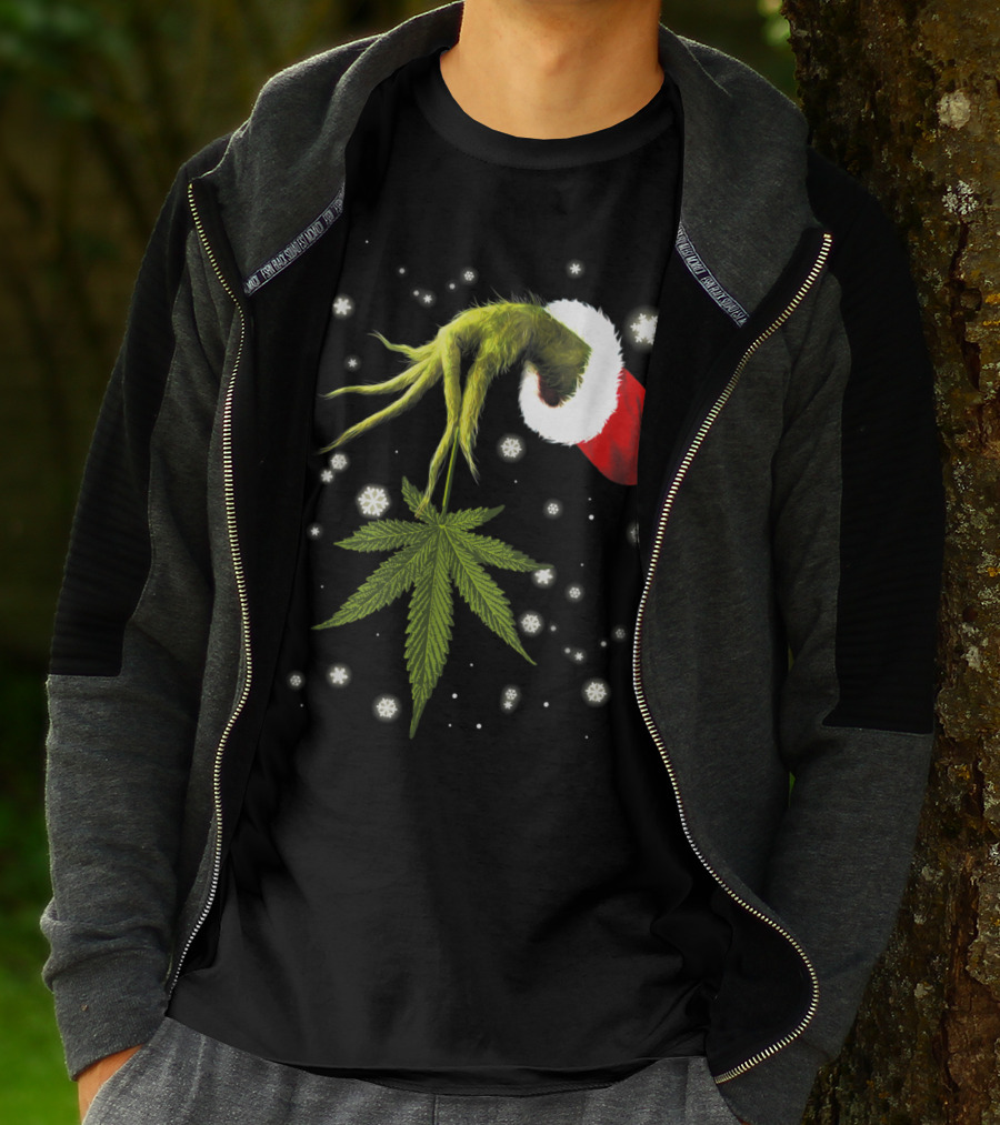 Grinch Hand Holding Cannabis Leaf With Santa Hat And Snowflakes T-Shirt