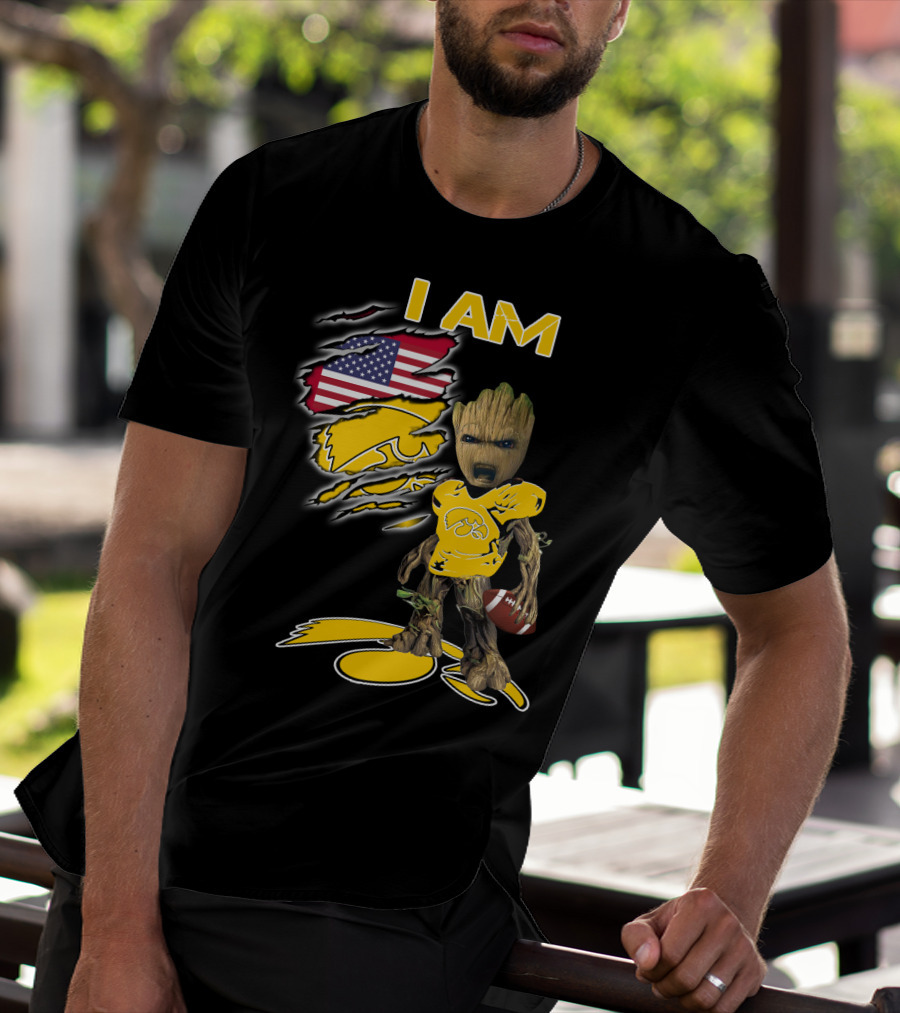 I Am Hawkeyes Baby Groot Holding Football With Usa Flag And Iowa Hawkeyes T-Shirt