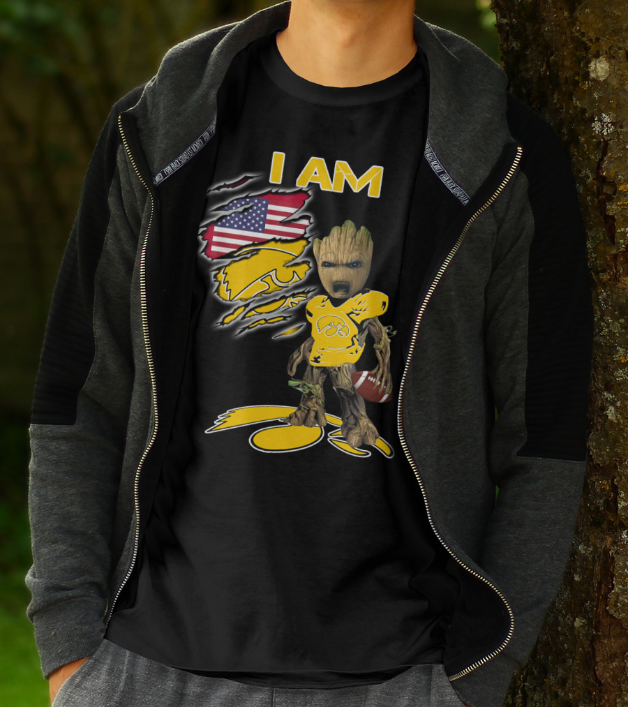 I Am Hawkeyes Baby Groot Holding Football With Usa Flag And Iowa Hawkeyes T-Shirt