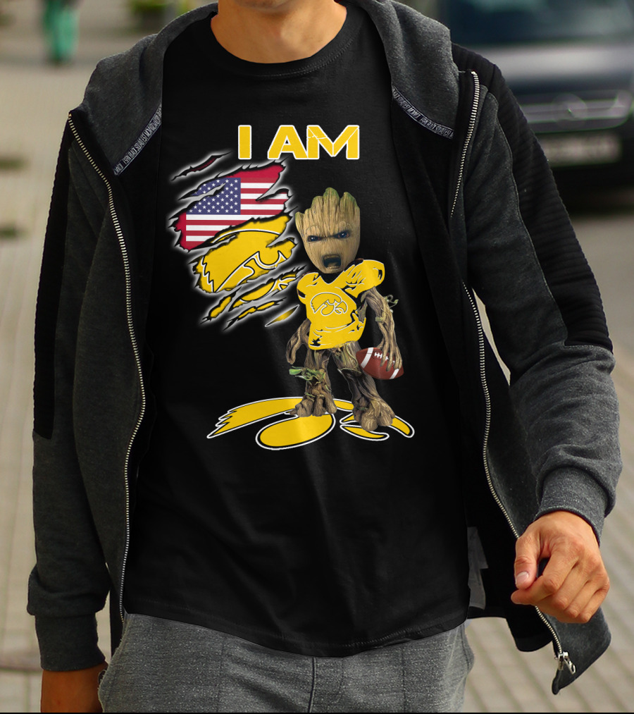 I Am Hawkeyes Baby Groot Holding Football With Usa Flag And Iowa Hawkeyes T-Shirt