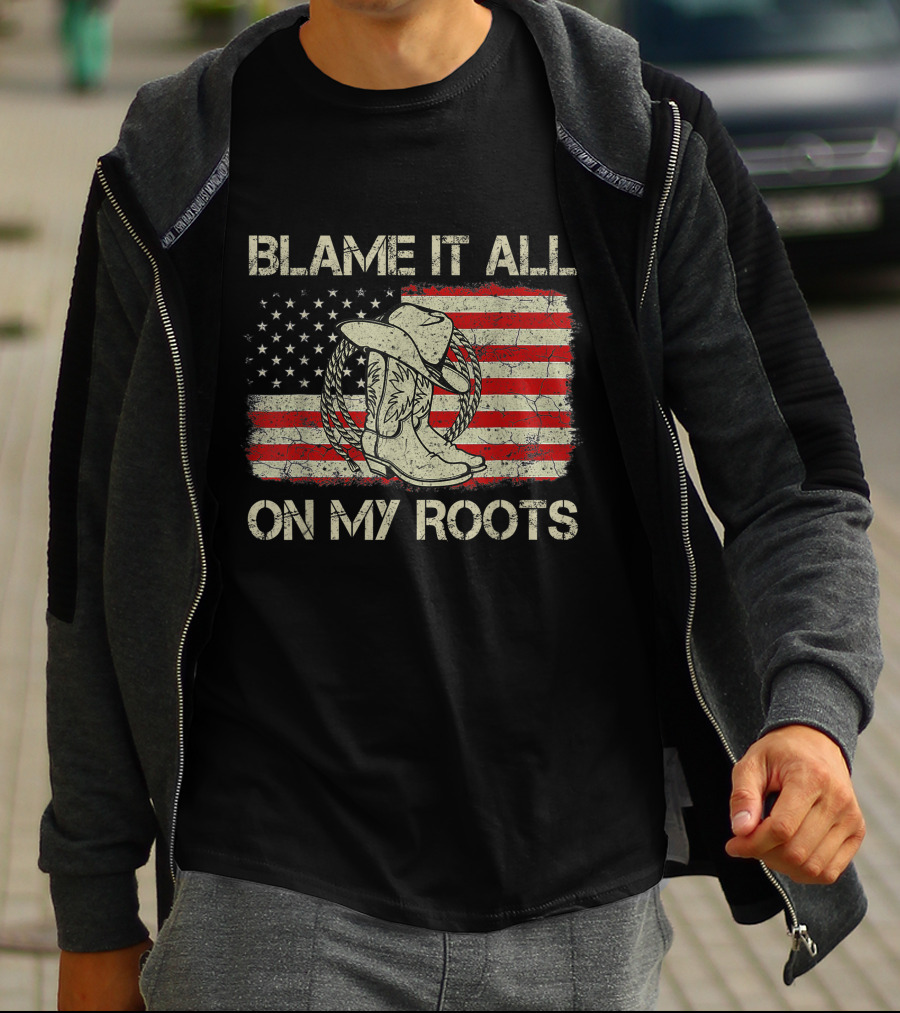 Blame It All On My Roots Cowboy Hat Boots American Flag Background T-Shirt