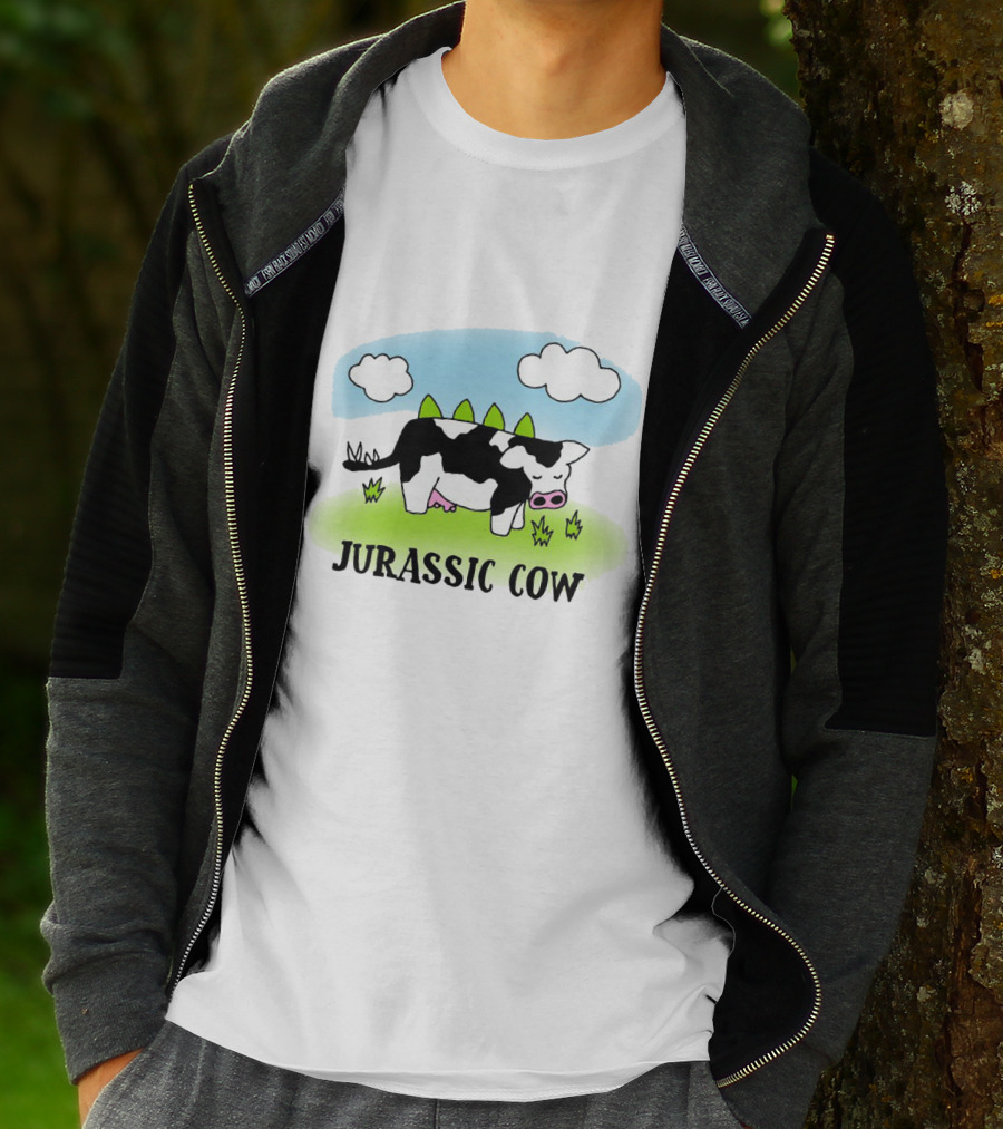 Jurassic Cow Grazing With Dinosaur Spikes Under Blue Sky And Clouds In Cartoon T-Shirt