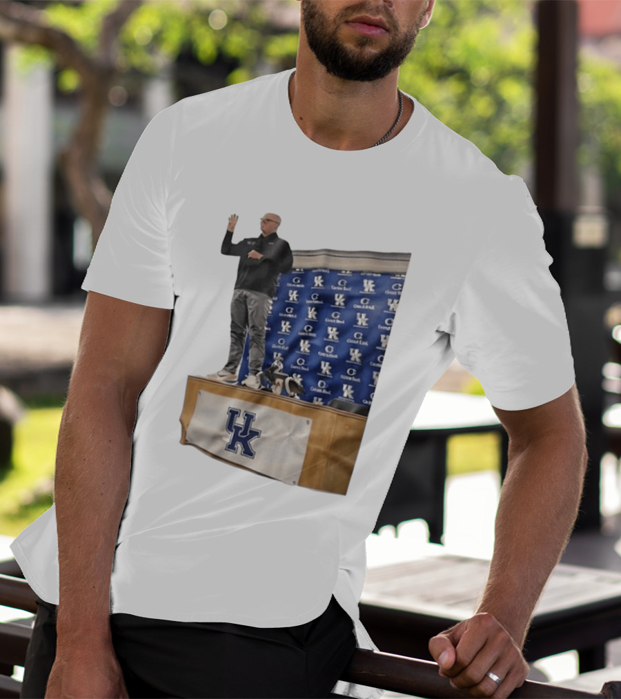 UK Volleyball Coach Craig Skinner Standing On Table With UK Logo And Awards T-Shirt