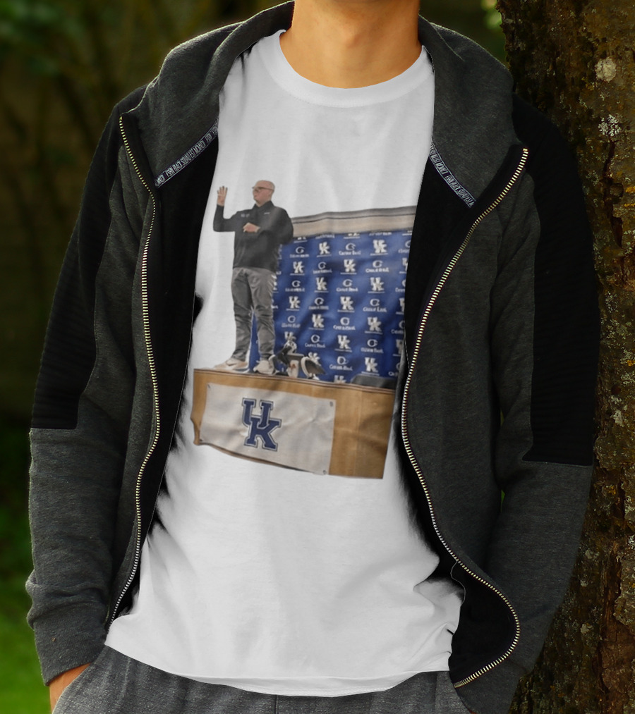UK Volleyball Coach Craig Skinner Standing On Table With UK Logo And Awards T-Shirt