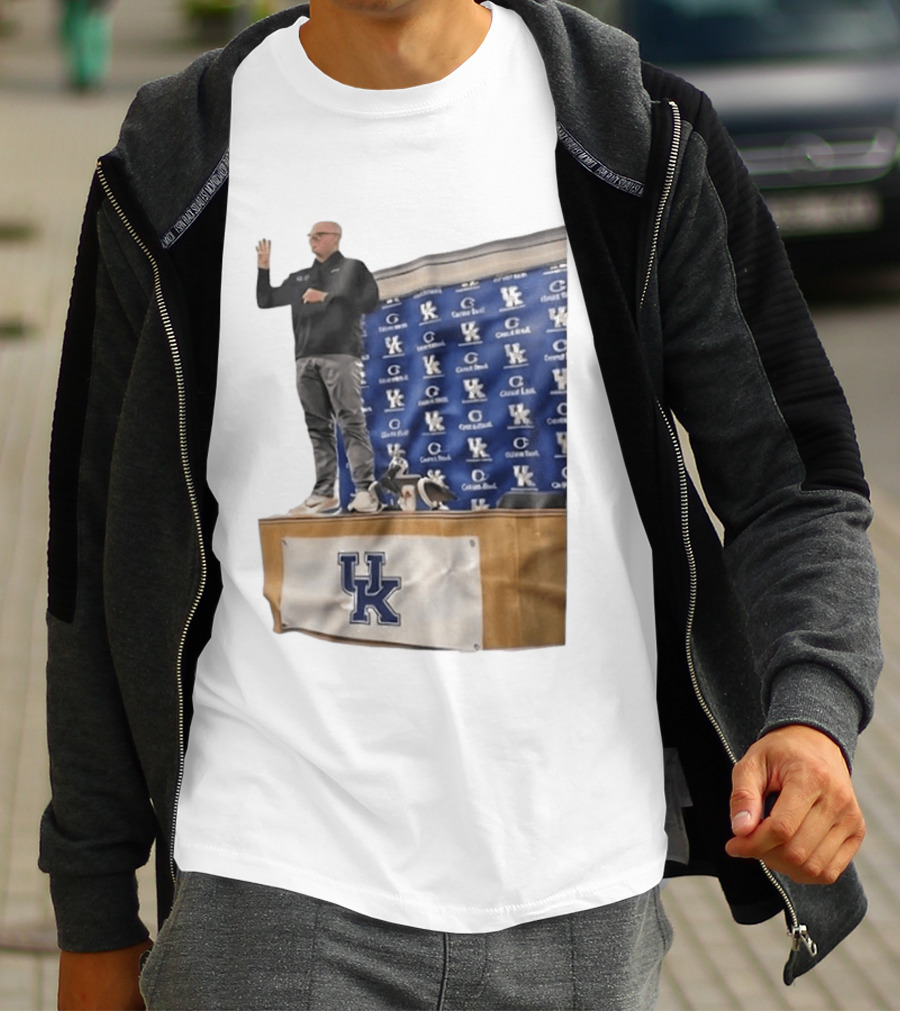 UK Volleyball Coach Craig Skinner Standing On Table With UK Logo And Awards T-Shirt