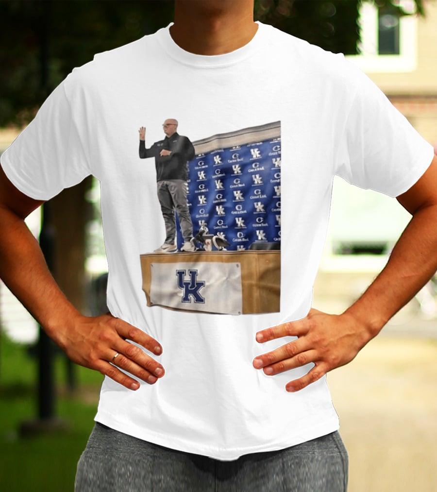 UK Volleyball Coach Craig Skinner Standing On Table With UK Logo And Awards T-Shirt