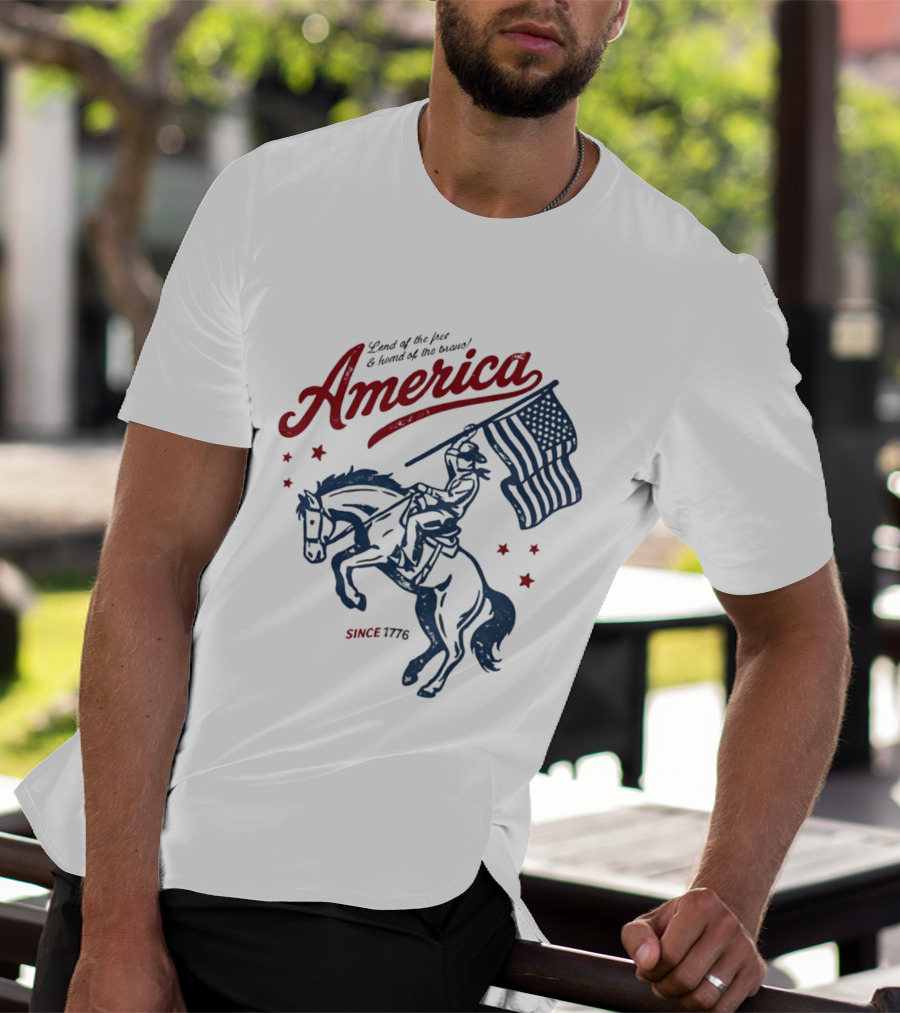 America Land Of The Free Home Of The Brave Since 1776 Cowboy Holding Flag Patriotic T-Shirt