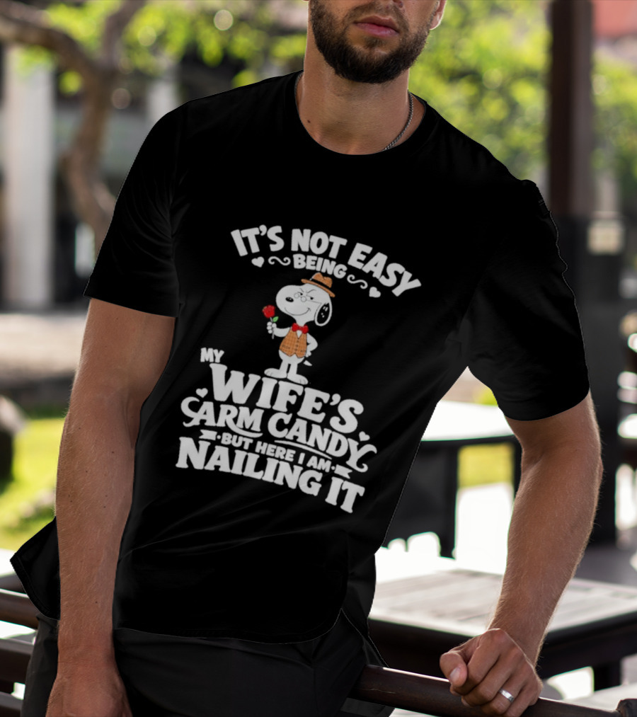 Snoopy It's Not Easy Being My Wife's Arm Candy But Here I Am Nailing It T-Shirt