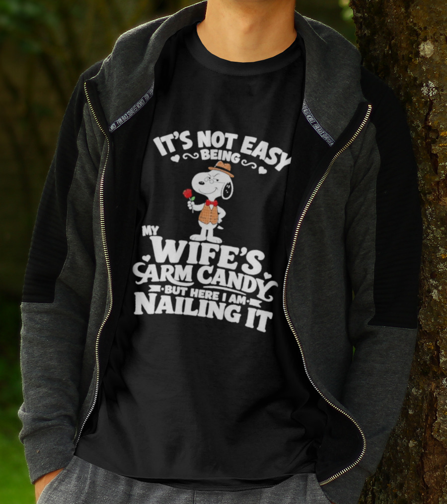 Snoopy It's Not Easy Being My Wife's Arm Candy But Here I Am Nailing It T-Shirt
