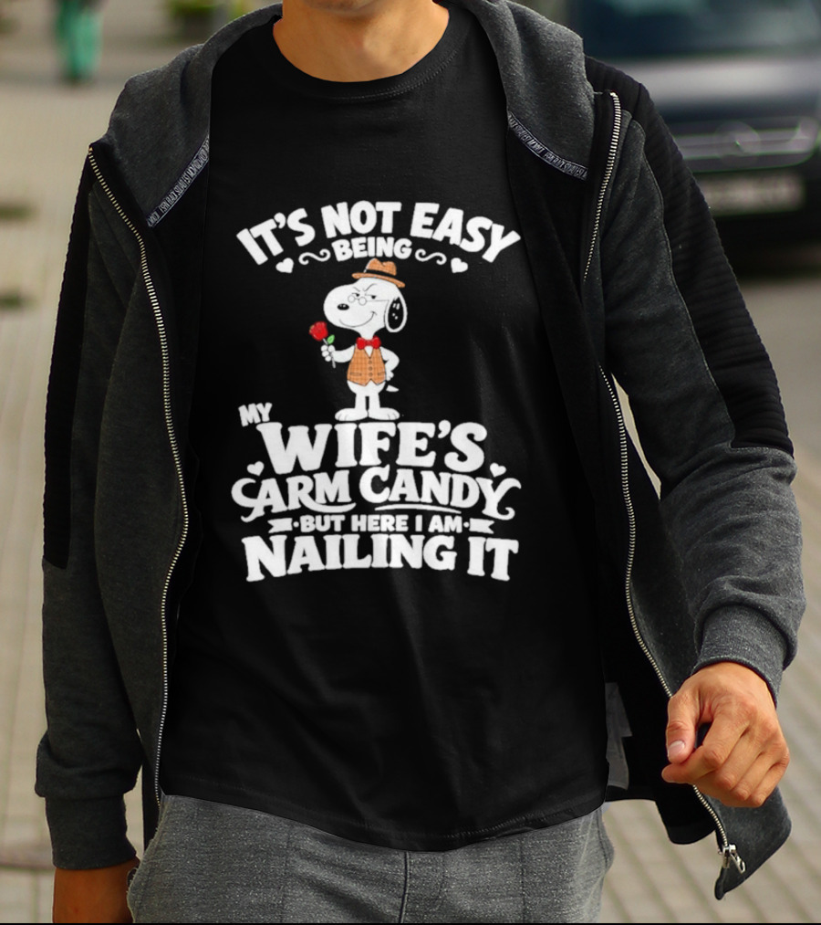 Snoopy It's Not Easy Being My Wife's Arm Candy But Here I Am Nailing It T-Shirt