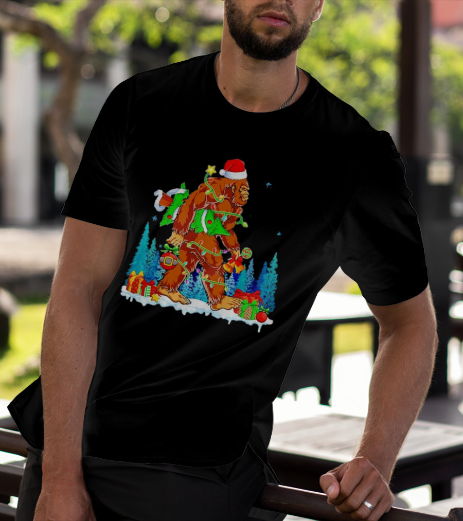 Bigfoot Santa Hugging Christmas Tree With Gifts And Snow Scene T-Shirt