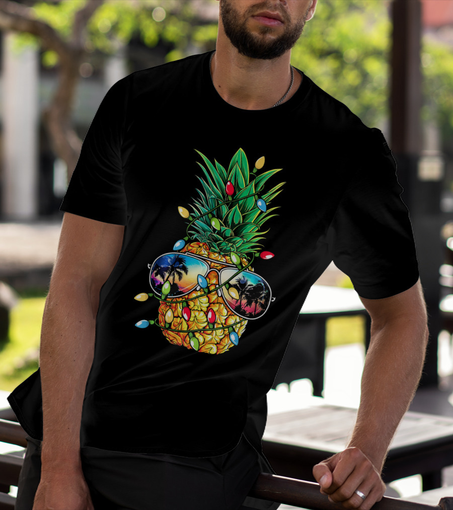Pineapple Wrapped In Christmas Lights With Sunglasses Reflected Sunset And Palm Trees T-Shirt