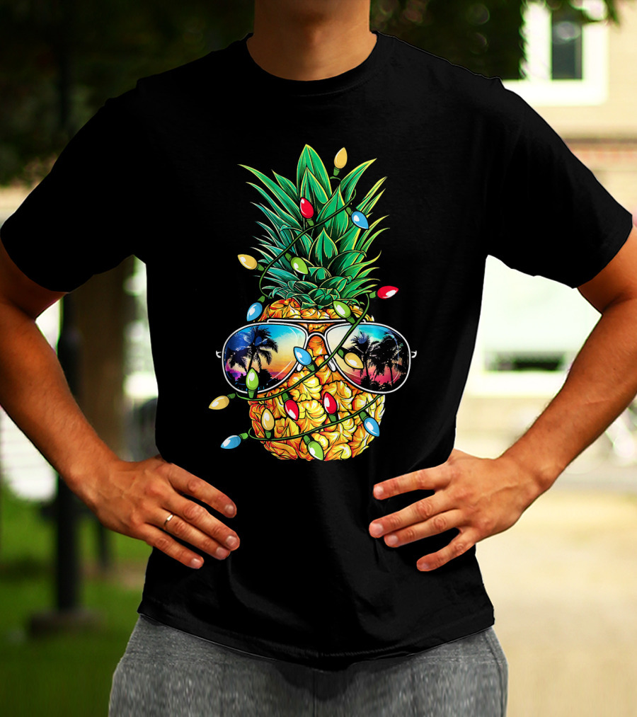 Pineapple Wrapped In Christmas Lights With Sunglasses Reflected Sunset And Palm Trees T-Shirt