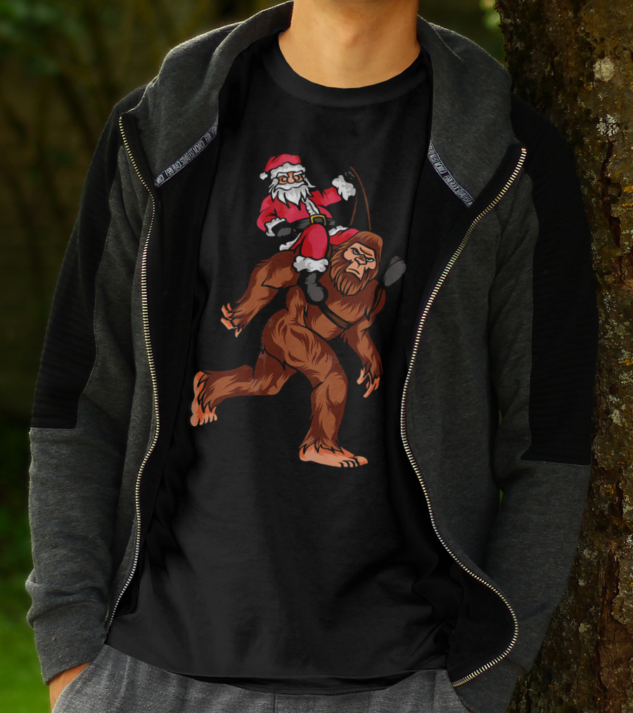 Bigfoot Carrying Santa Claus In Christmas T-Shirt